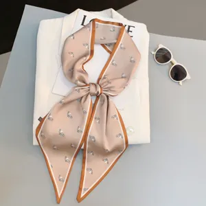 Chic narrow silk scarf with elegant horse print and contrast border, versatile for hair or neck.