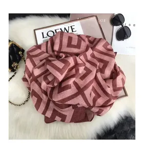 Detail view of the geometric patterned scarf showing soft cotton linen texture and stylish drape.