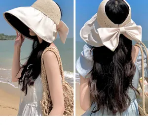 Detail view of the wide brim empty top sun hat with big bow, ideal for beach and summer use.