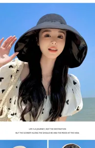Detail view of the wide brim empty top sun hat worn at beach, offering great UV protection.