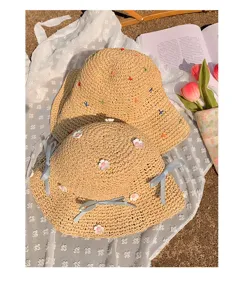 Women straw sun hat foldable beach hat with cute bows and floral embroidery picnic style.