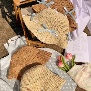 Woven straw sun hat with cute blue bow and floral embroidery, perfect for beach outdoor summer.