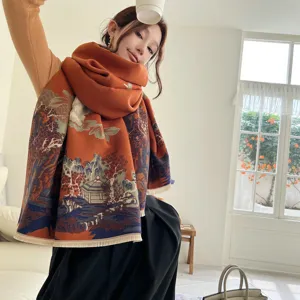 Detail view of thick orange cashmere-feel winter scarf with traditional Chinese landscape print.