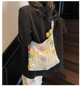 Detailed view of crocheted shoulder bag with 3D colorful sunflowers worn by model