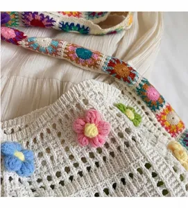 Hand-crocheted sunflower tote bag detail showing textures and colorful 3D floral accents