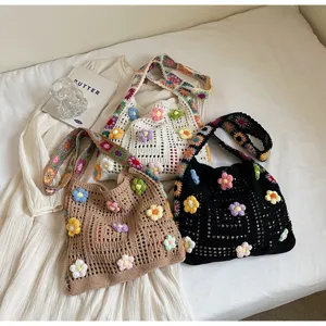 Group shot of three handmade crochet flower shoulder bags in white, brown, and black.