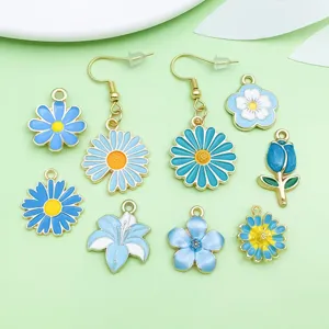Gros plan de pendentifs et boucles d'oreilles en émail bleu, détails d'accessoires de bijoux DIY.