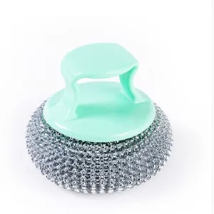 Detailed view of the kitchen cleaning brush with green handle and mesh scrubber head for pots.