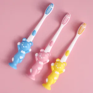 Cute cartoon bear kids soft bristle toothbrush with suction cup base, ideal for daily oral care.