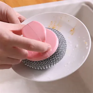 Multifunctional kitchen cleaning brush with pink handle and durable scrubber for dishes.