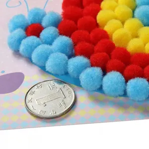 Detailed view of DIY pom pom craft kit for kids, colorful fluffy balls art materials.