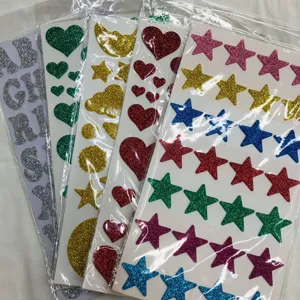 Glitter sticker sheets close-up, featuring colorful stars, hearts, and alphabet letters.