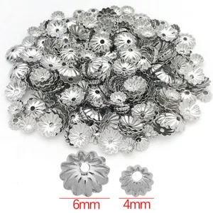 Close-up detail of silver pumpkin wave flower bead caps DIY jewelry making accessories.