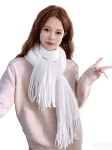 White knitted plush fringe scarf detail view, cozy winter fashion accessory for cold weather.
