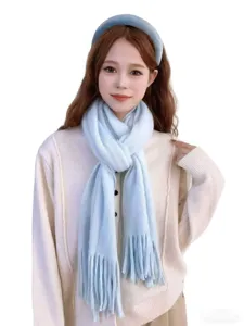 Light blue knitted fuzzy fringe scarf detail, soft autumn winter warm fashion accessory.
