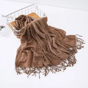 Brown wrinkled cotton linen scarf with tassels, versatile winter fashion shawl for women.