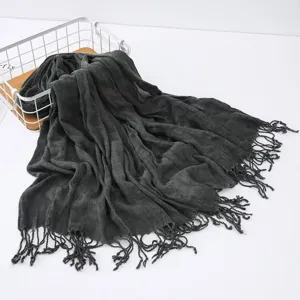 Dark grey crinkle linen scarf with frayed tassels, stylish winter shawl and versatile wrap.