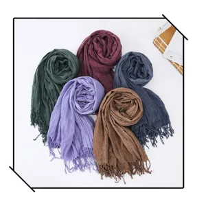 Close-up detail of multi-color cotton linen wrinkled scarves with stylish tassels for women.
