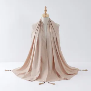 Details of beige tassel hijab scarf with silver wire trim and hanging beads for women fashion.