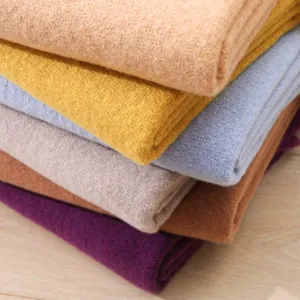 Close-up detail of soft solid color imitation cashmere winter warm long scarf fabric texture.