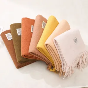 Detailed view of soft imitation cashmere solid color winter scarves with delicate fringe trim.