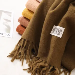 Cozy brown cashmere-feel winter tassel scarf with woven label, soft warm solid daily wear.
