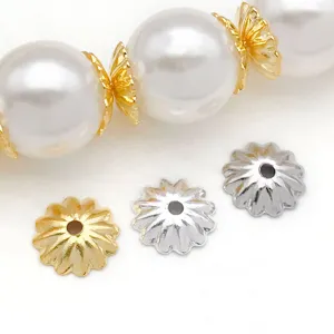 Detailed view of gold and silver plated metal wave bead caps for jewelry making and DIY crafts.
