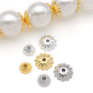 Close-up detail shot of exquisite gold and silver pumpkin wave flower bead caps for DIY jewelry.