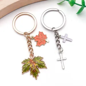 Metal alloy round keychain with maple leaf and cross charms, DIY jewelry accessories.