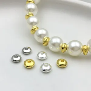 Detail shot of metallic gold and silver spacer beads, abacus and ufo shapes for DIY jewelry.