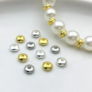 Gold and silver metal rondelle spacer beads for DIY jewelry making, bracelet design detail shot.