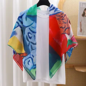 Detailed view of colorful abstract art print silk cotton scarf displayed on white tee.