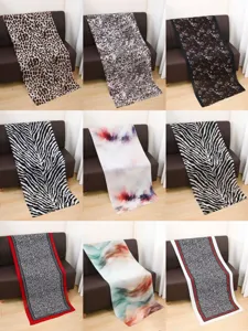 Detailed display of satin polyester long scarves featuring multiple animal and watercolor prints.