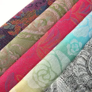 Ethnic bohemian paisley woven scarf fabric detail, vibrant colors, long elegant wrap.
