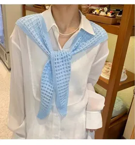 Detail view of a light blue hollow-knit decorative fake collar and stylish shawl.