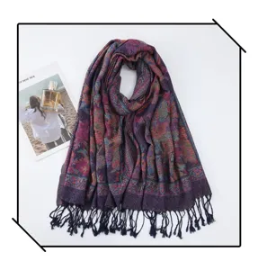 Ethnic style paisley embroidered tasseled scarf detail showing exquisite pattern and fringe.