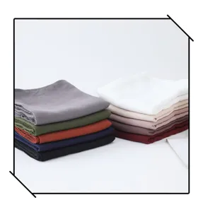 Vue détaillée de foulards pliés effet lin multicolores, texture douce et teintes riches.