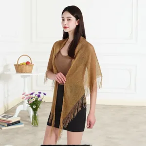 Detailed view of the gold metallic fringe triangle shawl, elegant hollow-out summer cape.