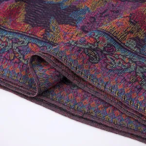 Close-up detail of the woven ethnic paisley fabric, showing rich colorful texture and pattern.