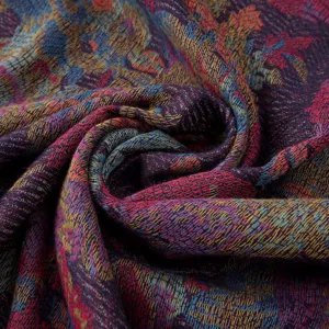Close-up detail of ethnic paisley jacquard woven scarf fabric with rich colorful pattern.