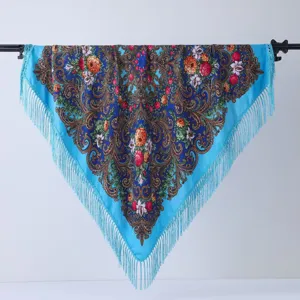 Detailed view of traditional ethnic floral print shawl scarf with delicate blue fringe trim.
