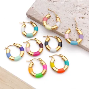 Detailed close-up shot of colorful enamel gold-plated hoop earrings, vibrant jewelry style.