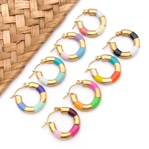 Close-up detail of colorful enameled bamboo hoop earrings, stainless steel jewelry.