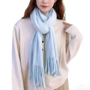 Light blue knitted fuzzy tassel scarf for women, warm winter fashion accessory and stylish wear.