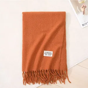 Cozy winter long cashmere-feel scarf with chic fringe and stylish woven label detail.