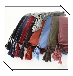 Detail view of multi-color fashion tassel beaded scarf hijab shawl with silver edges.