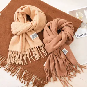 Cozy autumn winter imitation cashmere long scarf with stylish fringes and label detail.