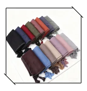 Detailed view of fashionable multi-color tassel beaded hijab scarfs with silver edge trim.
