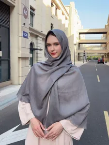 Detailed view of the soft slub scarf worn elegantly outdoors, lightweight breathable fabric.