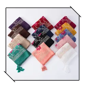 Multicolor embroidered tassel scarves close-up, elegant geometric and floral details, soft fabric.